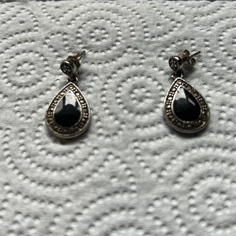 Women’s dark colored metal with black stone.